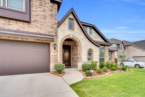 Enter your home through an elegant 8' wooden door  from the freshly landscaped yard