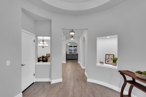 Step into a beautiful Rotunda foyer with niches, recessed ceiling, and other architectural details that continue throughout