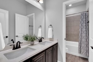 The secondary bedrooms downstairs have sufficient access to a full bath with tiled shower and tub area