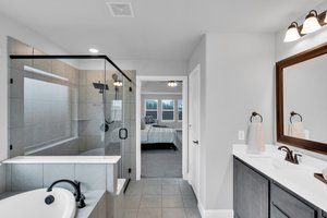 The home is thoughtfully designed with a luxurious oversized primary suite downstairs