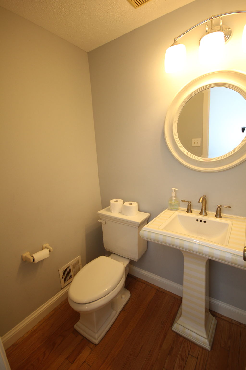 Charming half-bath with modern touches.