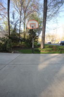 Regulation sized basketball hoop in driveway
