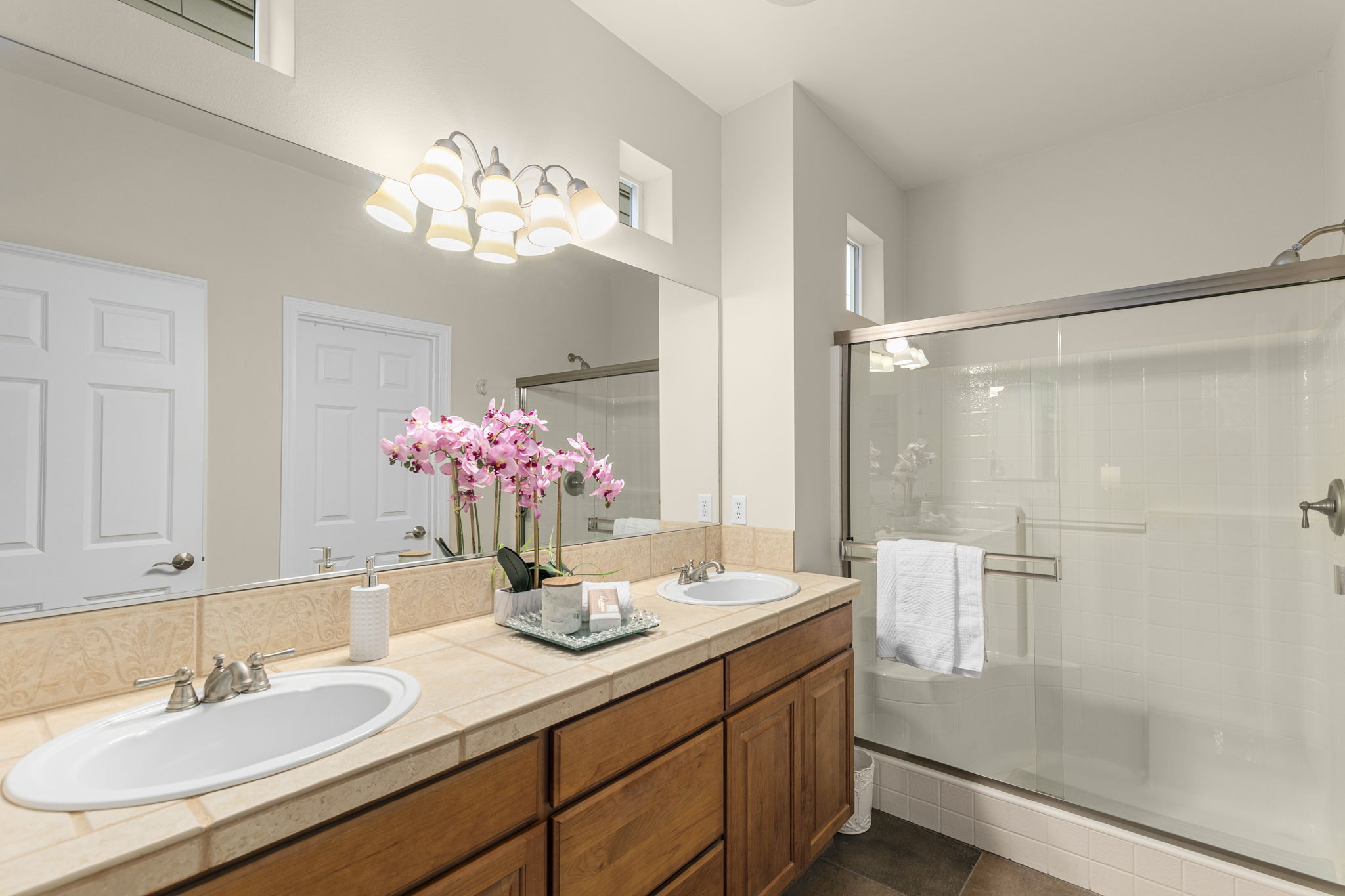 Dual vanity and low-step shower, large walk-in closet and WC.