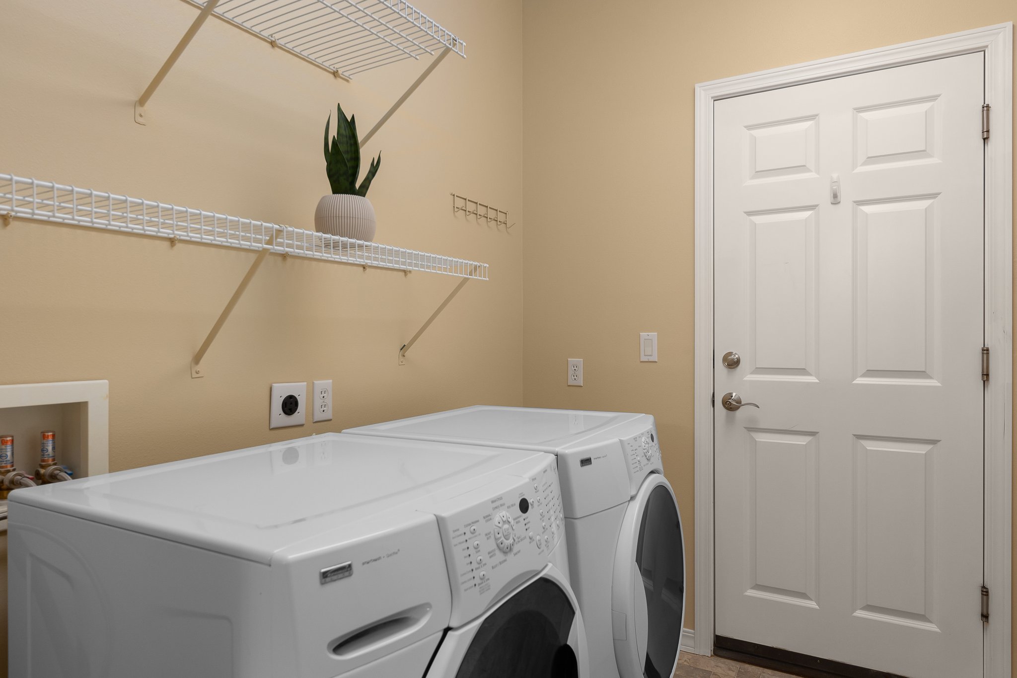 Main floor laundry with additional storage.