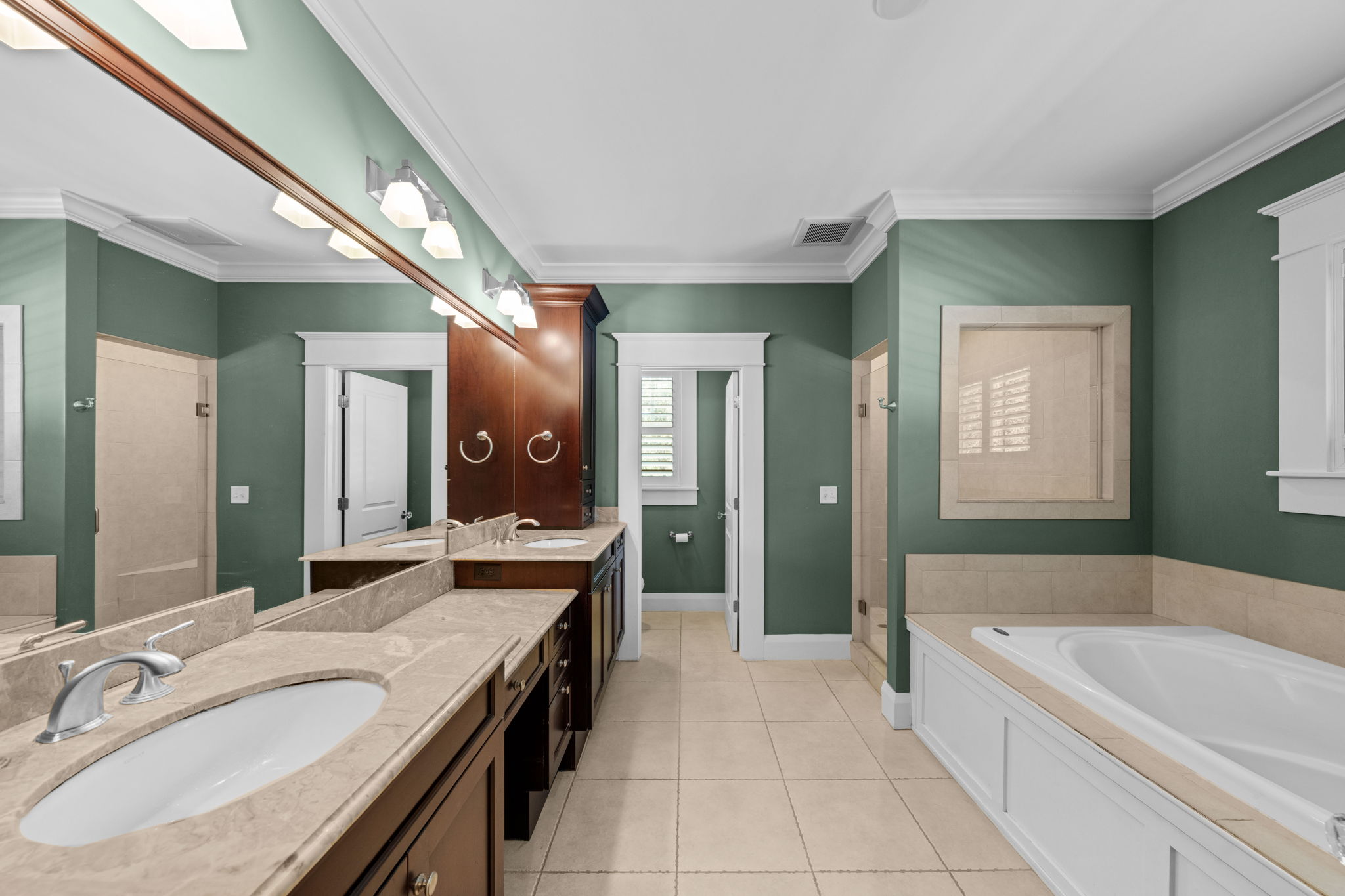 The bathroom features a garden tub, walk in shower