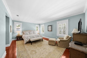 The primary bedroom is spacious and offers two walk in closets with shelving