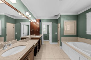 The bathroom features a garden tub, walk in shower