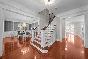 Features include high ceilings, crown molding and wood floors