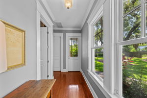 Beyond the kitchen find a full bath and mudroom by garage entrance