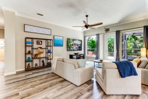 The living area features an abundance of glass...