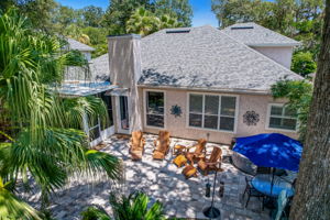 Palms and other tropical vegetation delightfully frame the backyard