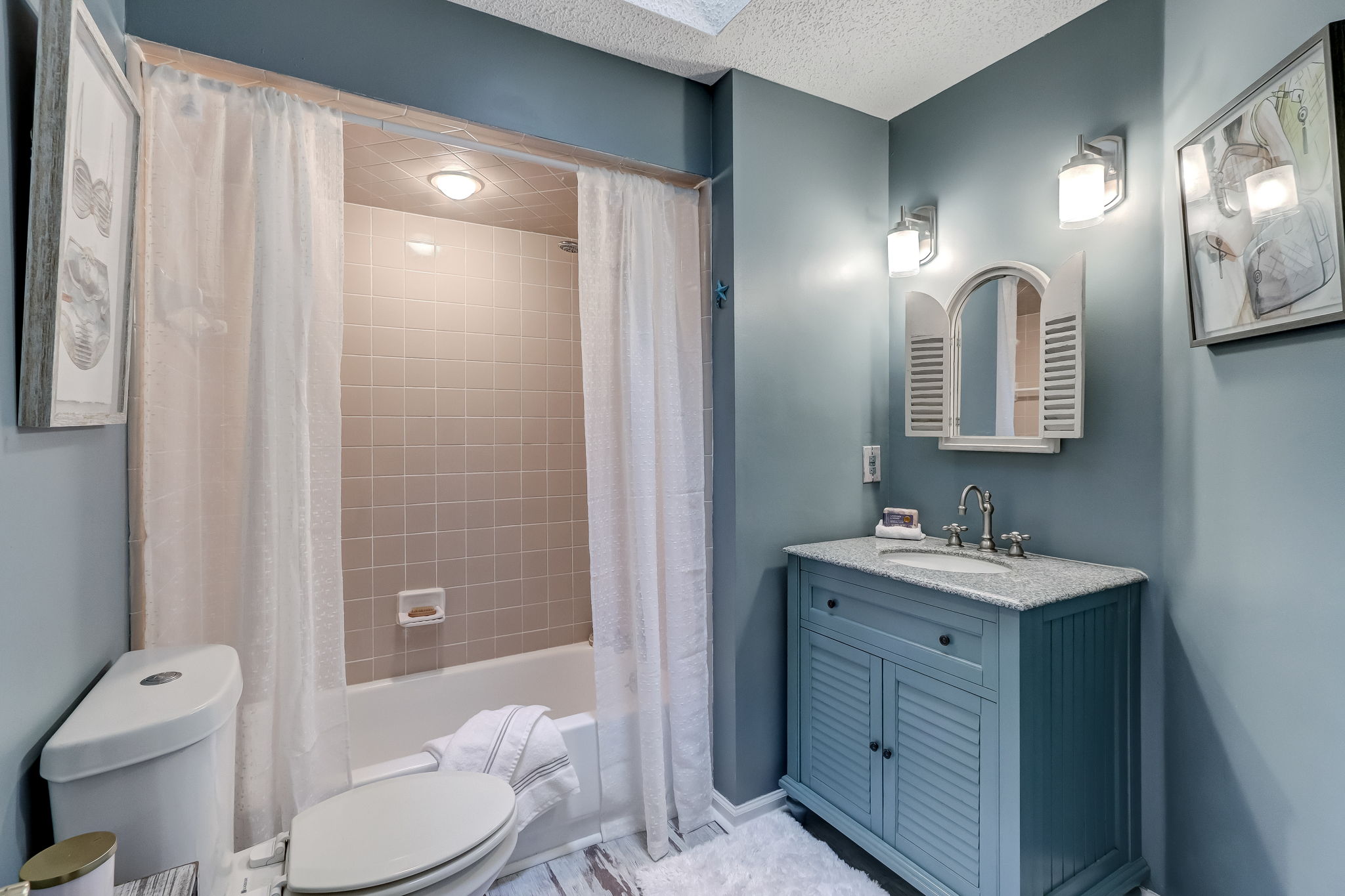 The guest bath features a tub/shower combo with updated vanity and fixtures