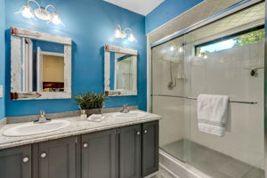 The master bath offers a dual sink, expansive walk-in shower, and private water closet.