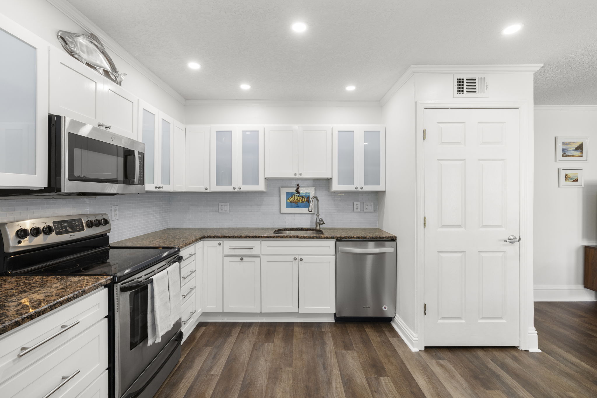 Granite countertops * Glass tile backsplash - Newer stainless steel refrigerator, dishwasher & microwave