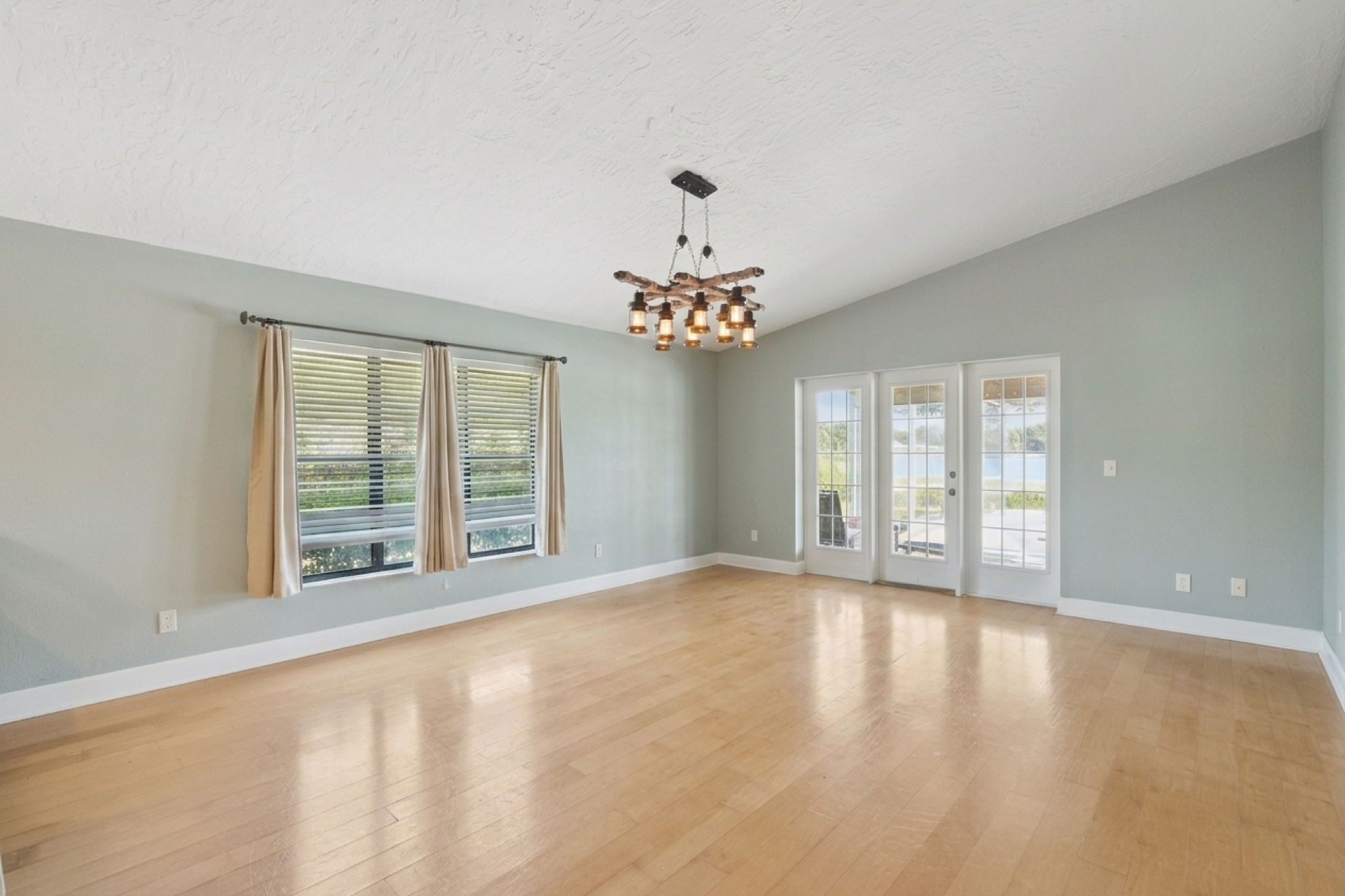 Dining room featuring beautiful glass windowed doors leading to the patio and pool.
