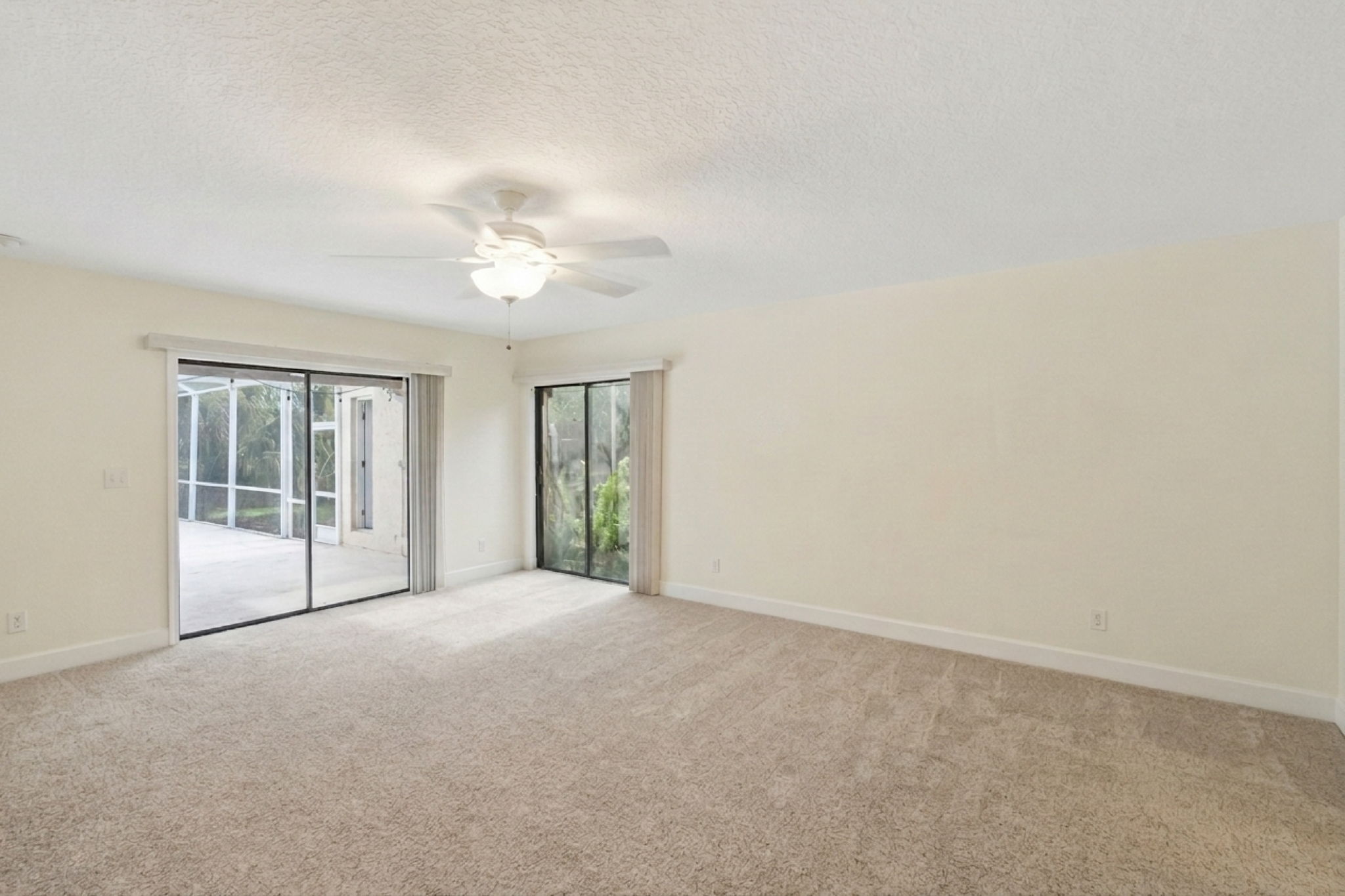 Primary Suite with double sliding glass doors and access to the pool/patio.
