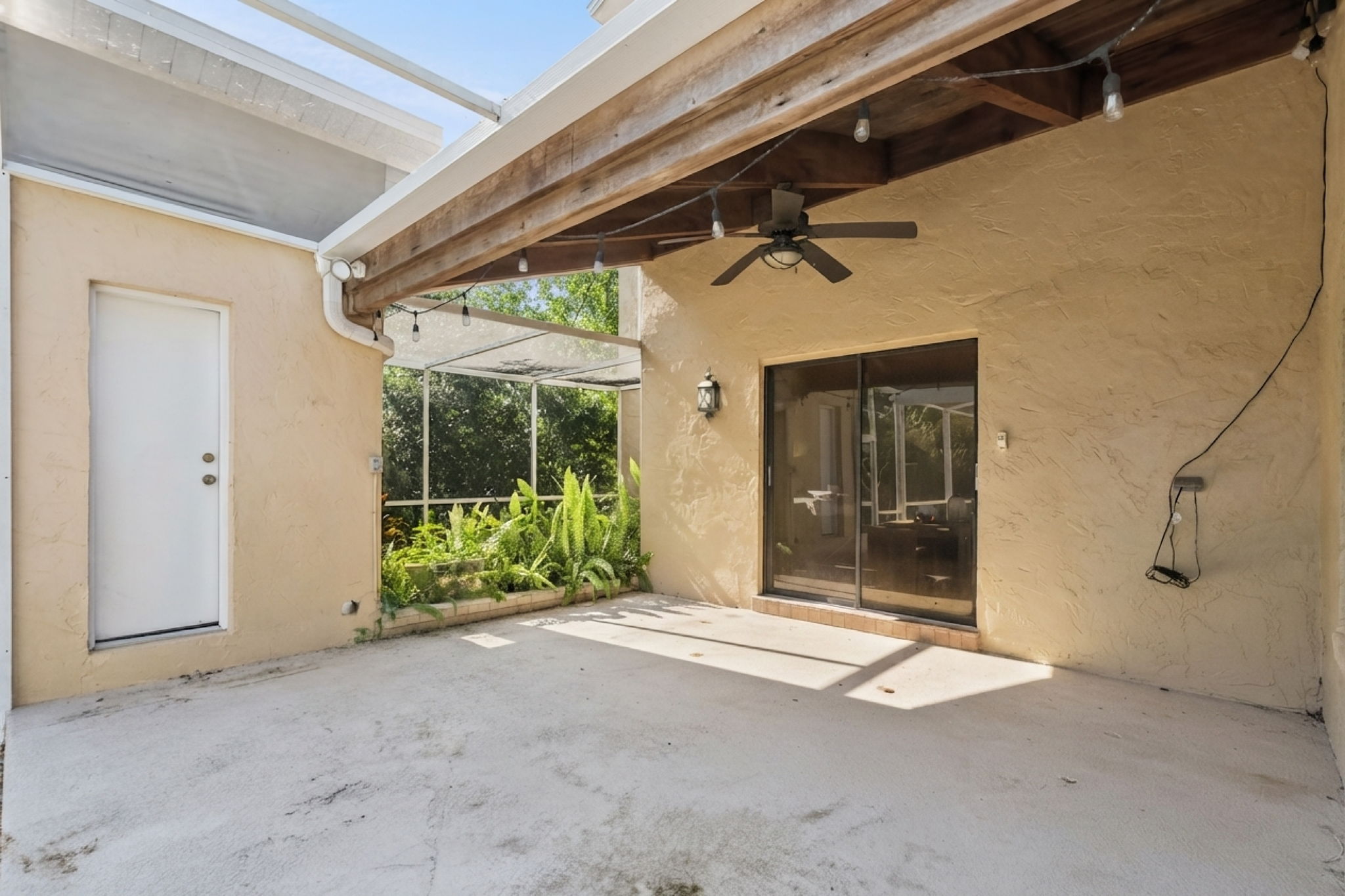Door to outside pool bath. Screened in gardening area. Covered patio area with entry to the primary suite through glass sliders.
