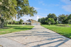 Aerial view showcasing the beautiful chain of lakes surrounding the area, highlighting the home’s exceptional lakefront setting and the natural beauty of its surroundings.