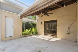 Door to outside pool bath. Screened in gardening area. Covered patio area with entry to the primary suite through glass sliders.