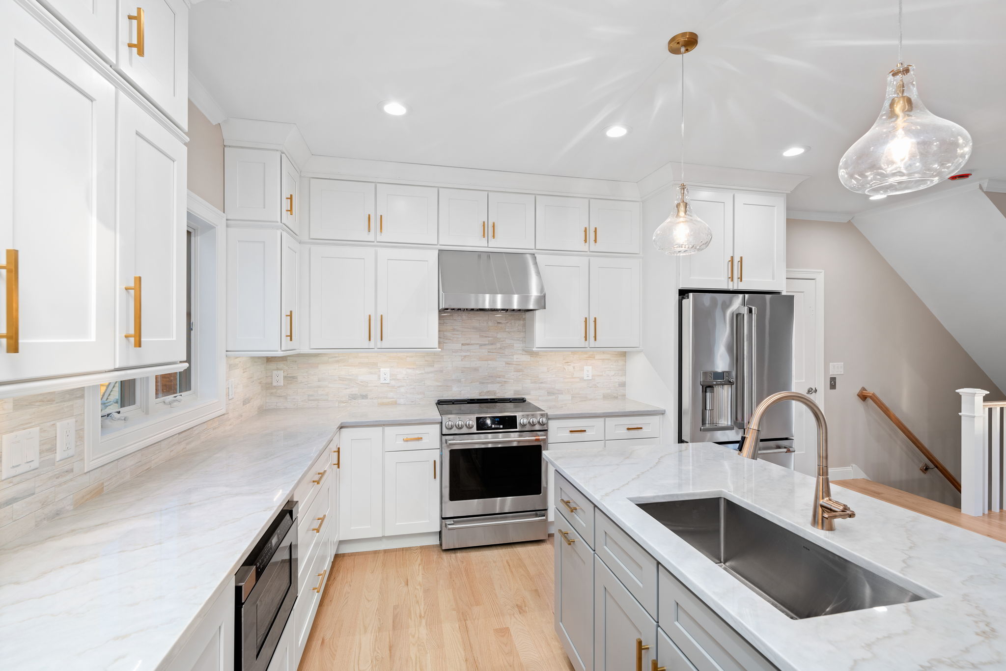 Timeless and crisp white kitchen with quartzite counters