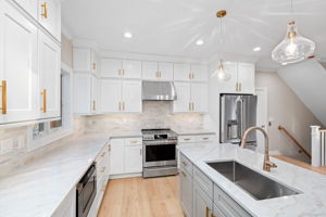 Timeless and crisp white kitchen with quartzite counters