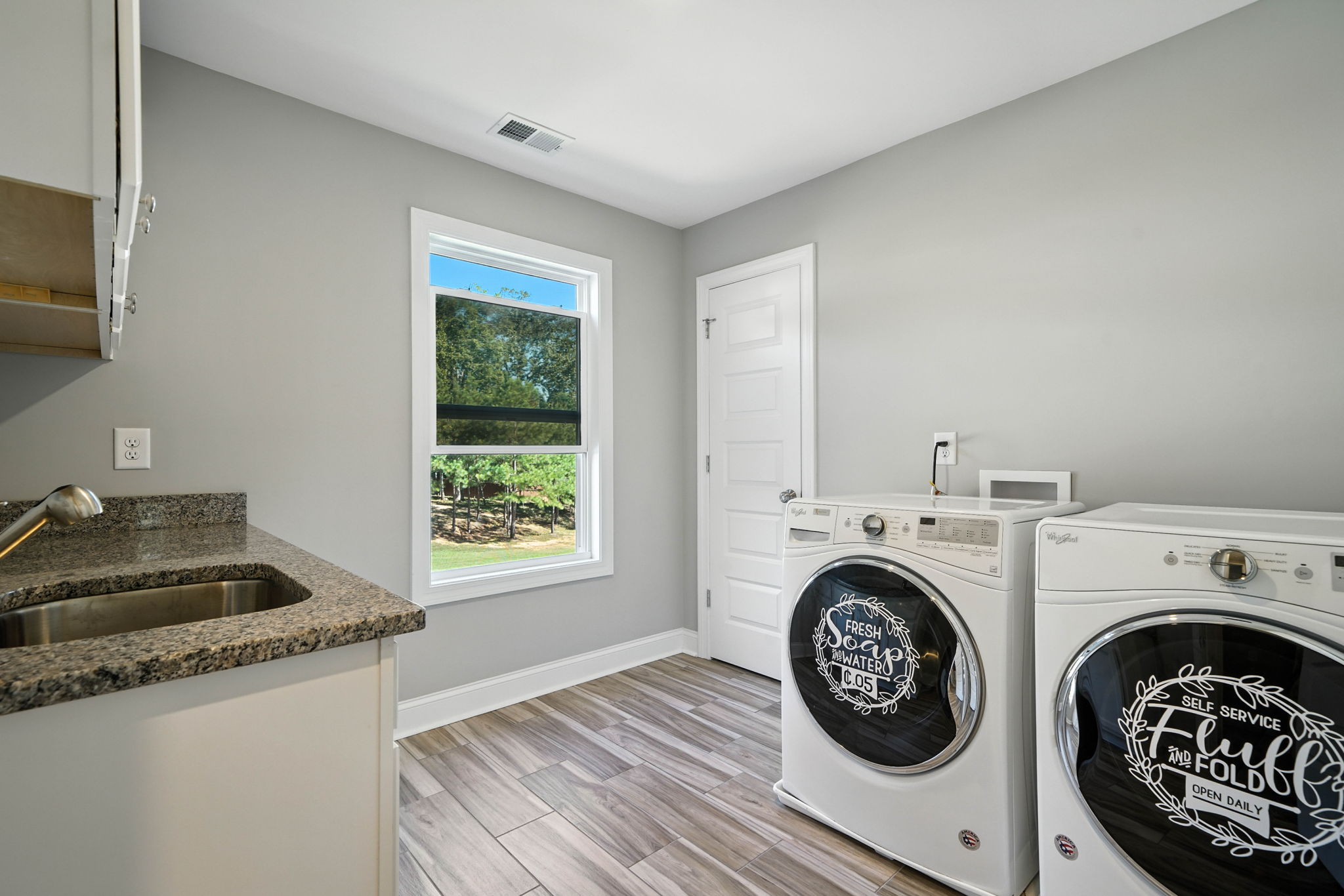 Upper Level Laundry Room with Sink and Storage