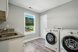 Upper Level Laundry Room with Sink and Storage