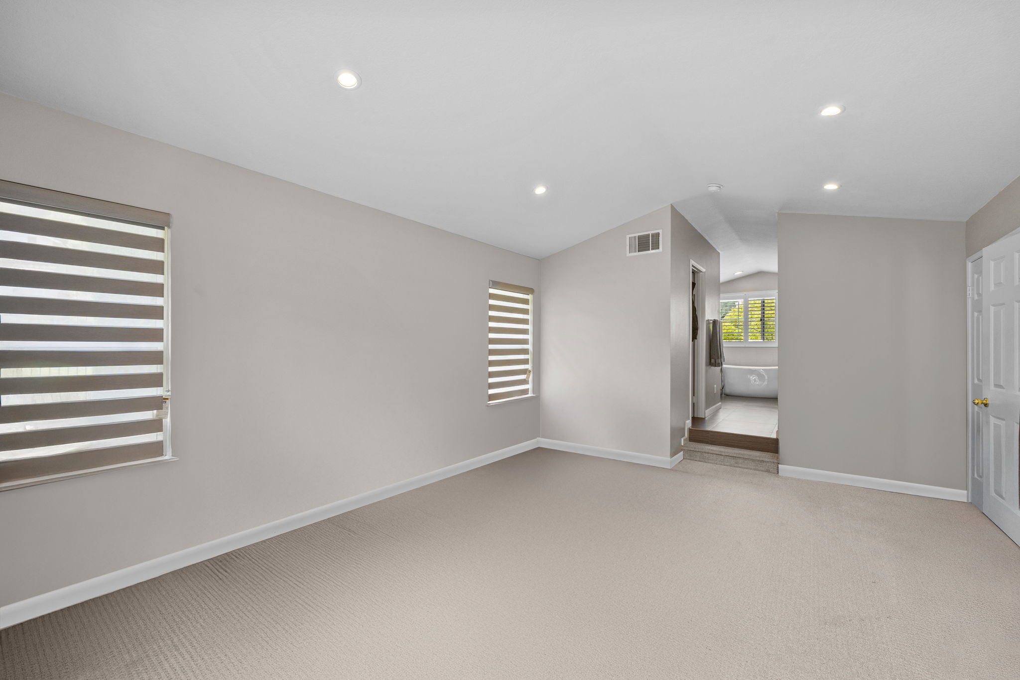 Upstairs primary room, virtually staged and decluttered