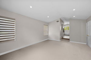 Upstairs primary room, virtually staged and decluttered