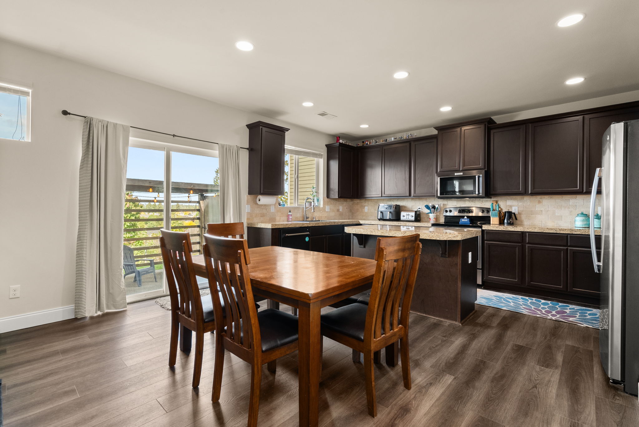 Open dining and kitchen area with sliding-door access to the backyard patio.