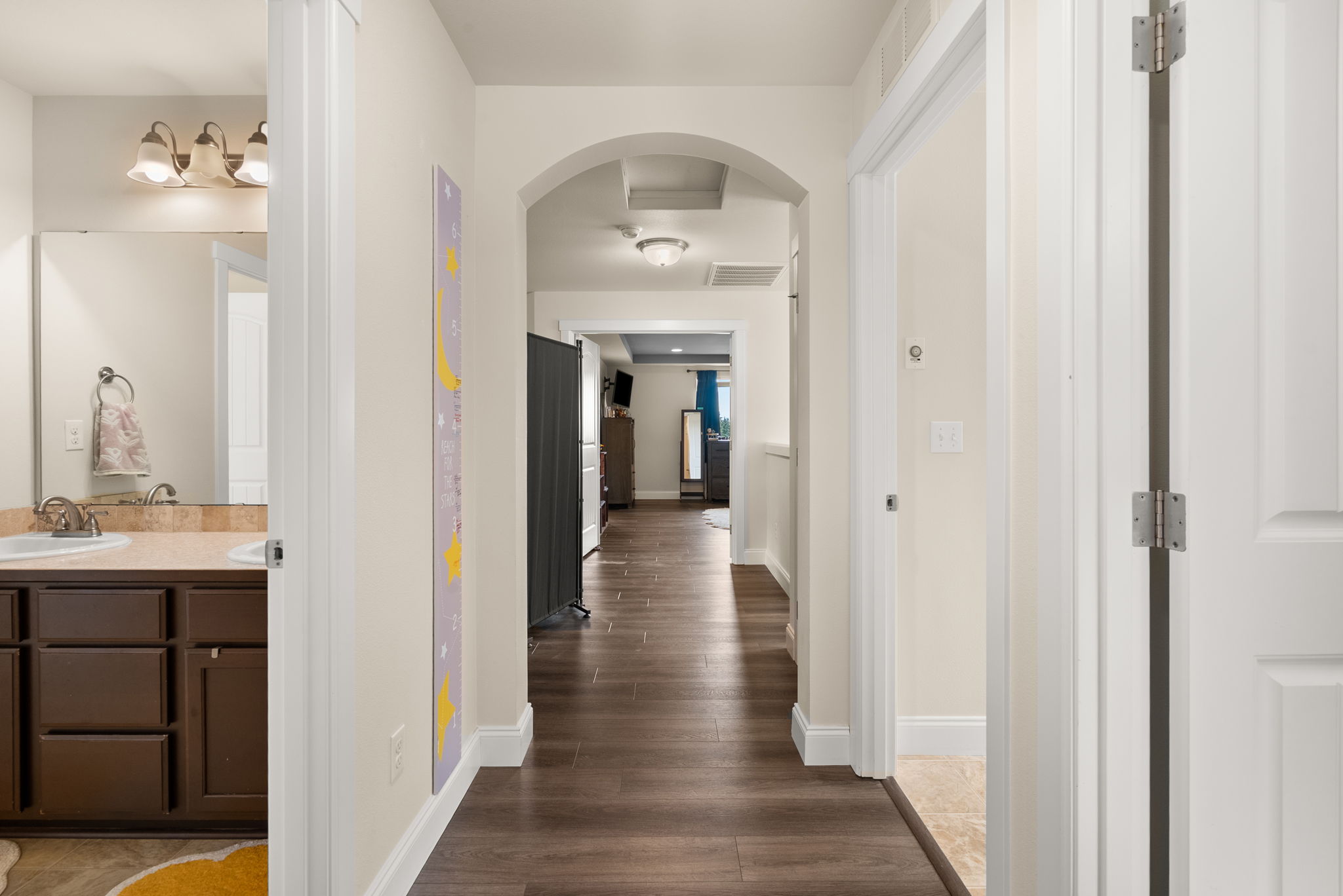 Upstairs hallway connecting the bedrooms, bathrooms, and laundry.