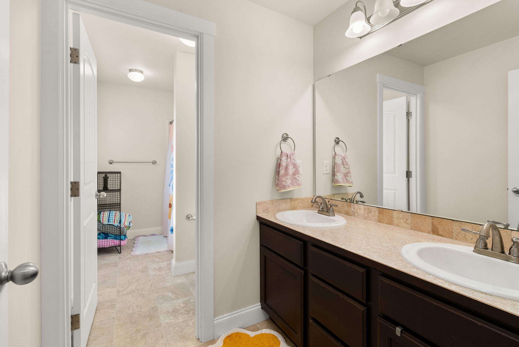 Upstairs full bathroom with double-sink vanity.