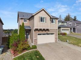 Well-maintained exterior with mature landscaping and attached 2-car garage.