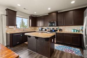 Well-appointed kitchen with generous counter space, 42-inch cabinetry and center island.