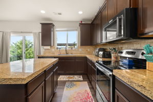KitchenAid appliances, abundant cabinetry and generous workspace make this kitchen both functional and inviting.