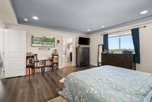 Generous primary bedroom filled with natural light and access to the private ensuite.