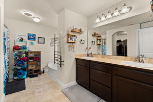 Private 5-piece primary bath with dual vanities, heated towel warmer, Bluetooth bathroom fan and walk-in closet.