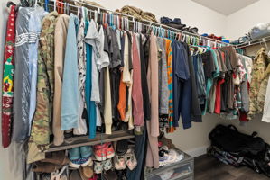 Spacious primary walk-in closet with plenty of storage.