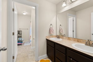 Upstairs full bathroom with double-sink vanity.