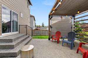 Backyard patio with covered seating area and easy access from the home.
