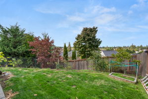Fully fenced backyard with usable lawn and room to garden or play.
