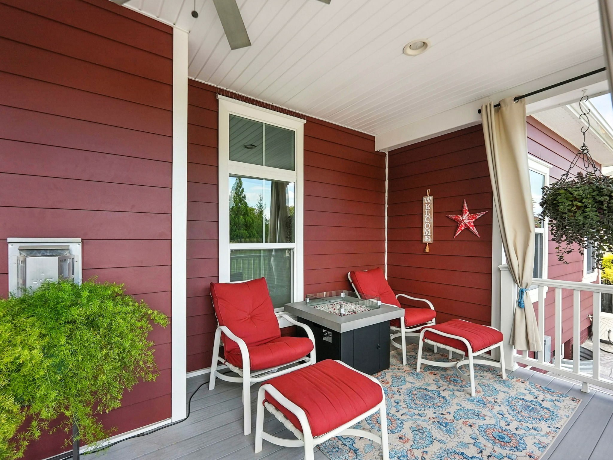 Covered patio with ceiling fan & drapes for privacy