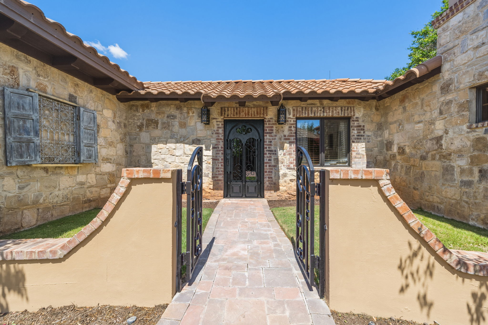 Private-entry gate to the guest villa provides the perfect space for a home office or a guest suite.