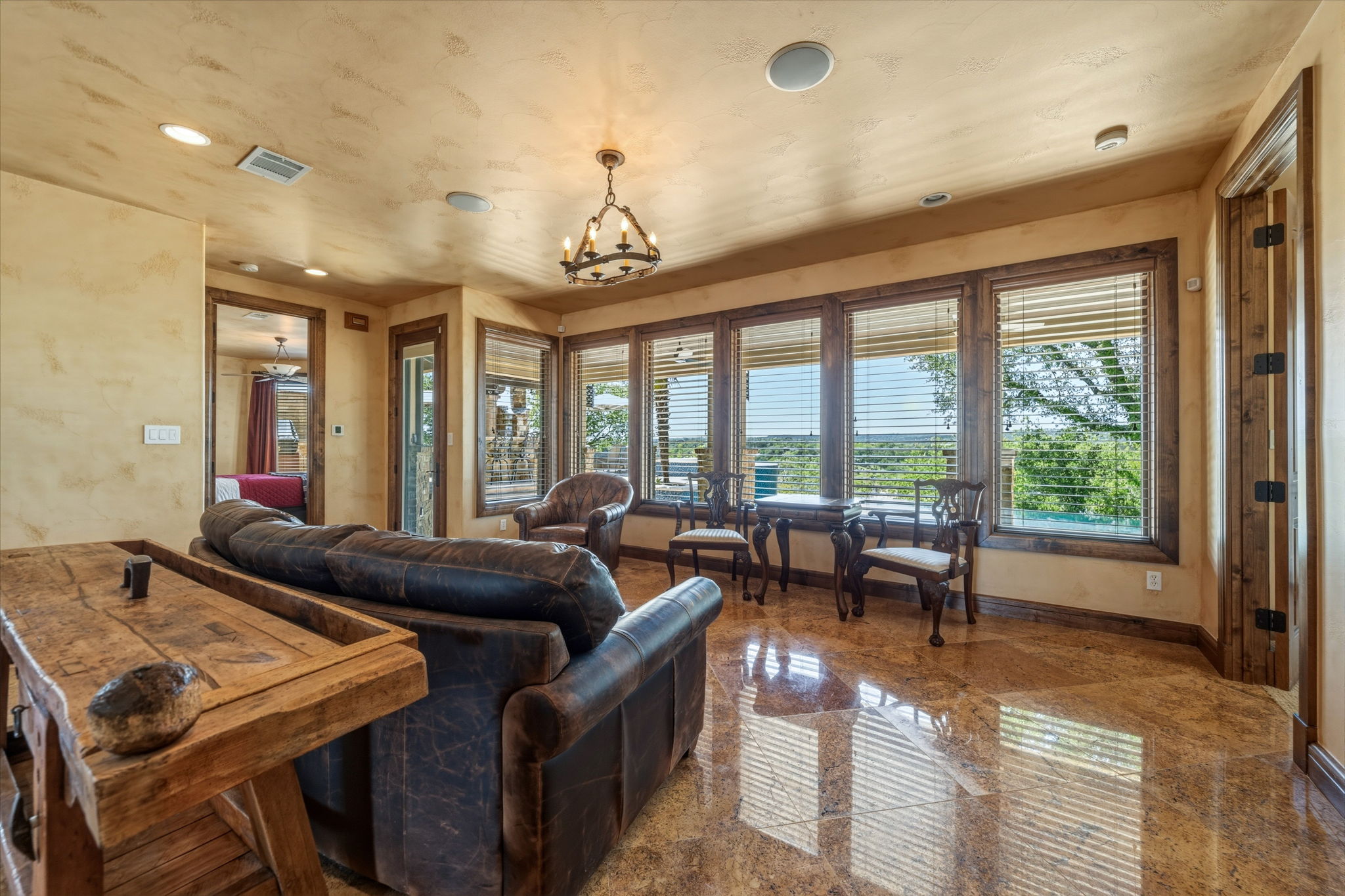 The lower level living area has direct access to the outdoors and  expansive windows offering views of the surrounding landscape.