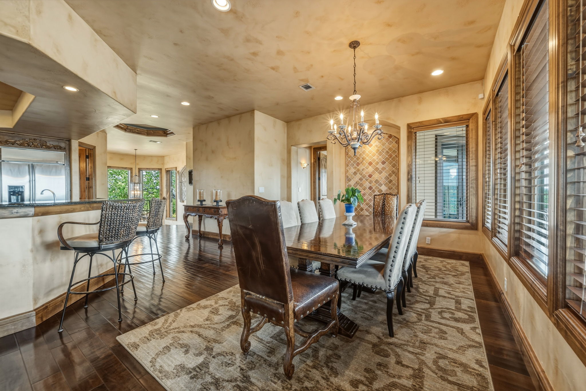 Dining area provides waterfront views and features hardwood floors, a chandelier,