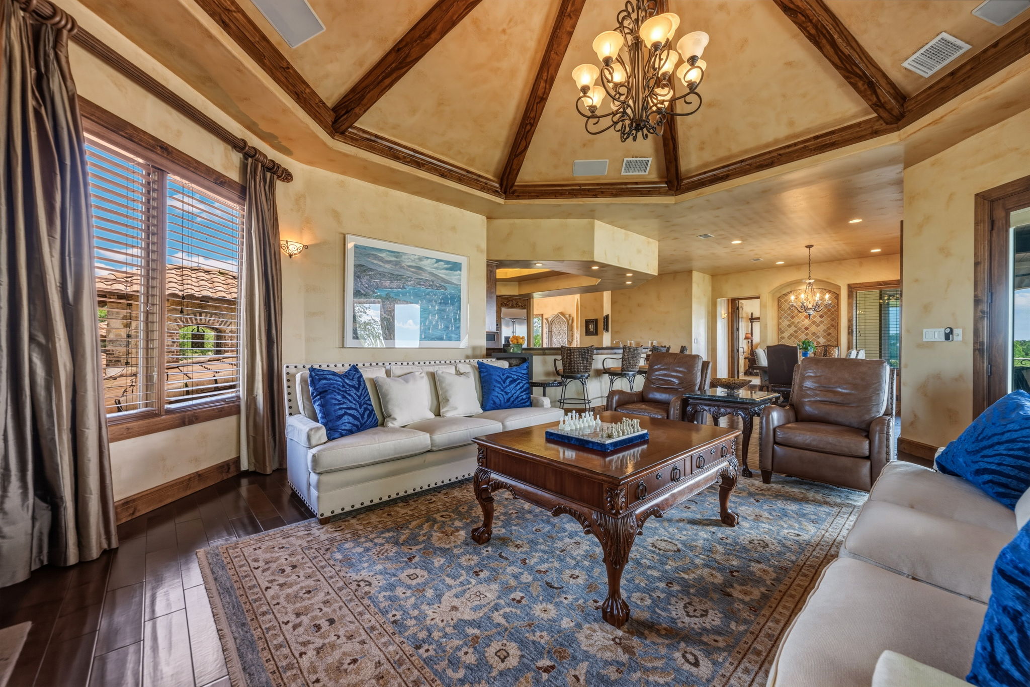 Enjoy relaxing in the living area which features a high vaulted ceiling with exposed wooden beams.