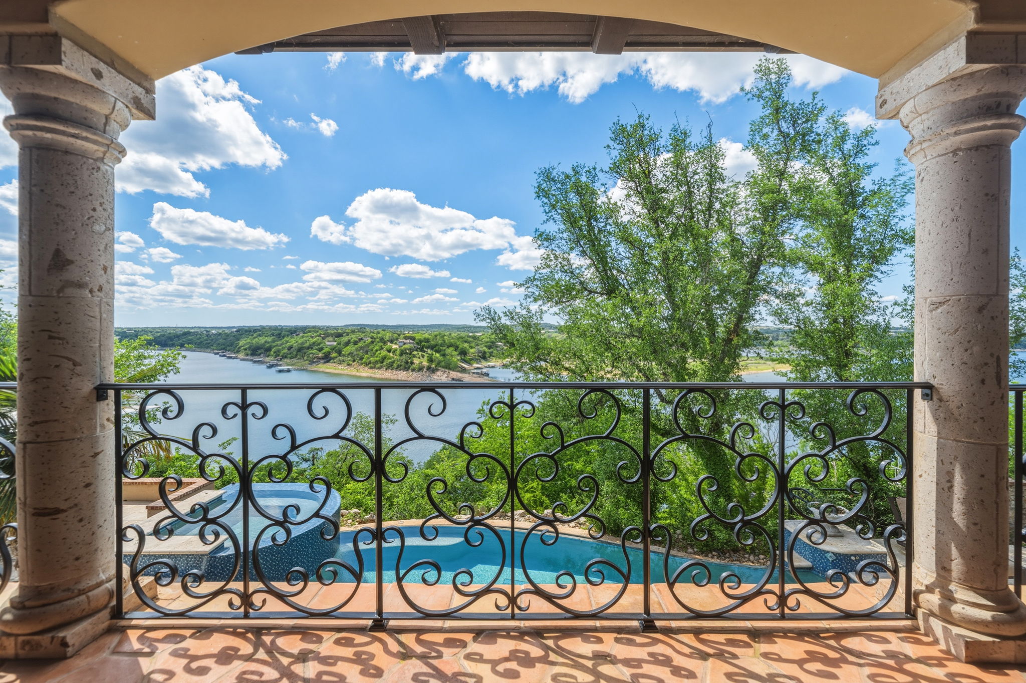 Glaze out at the beauty of the hill country on your covered porch with patterned tile flooring and stone pillars.