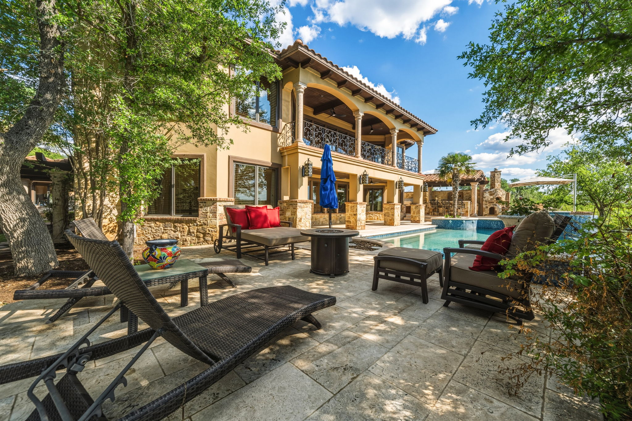 Relax and enjoy the expansive outdoor living area with a pool and patio.
