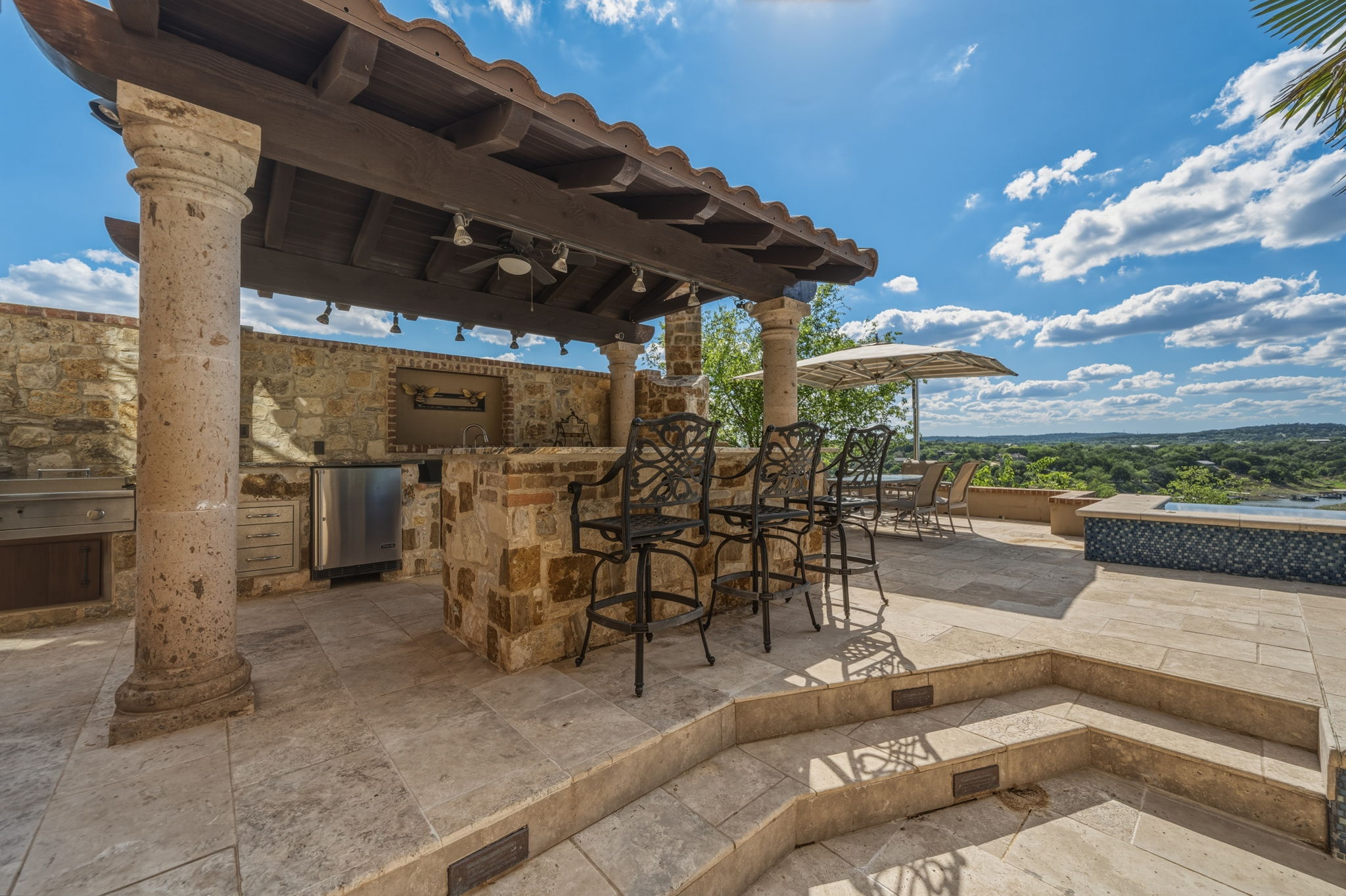 Outdoor living at its best with a full kitchen, granite counters, and spectacular waterfront views.