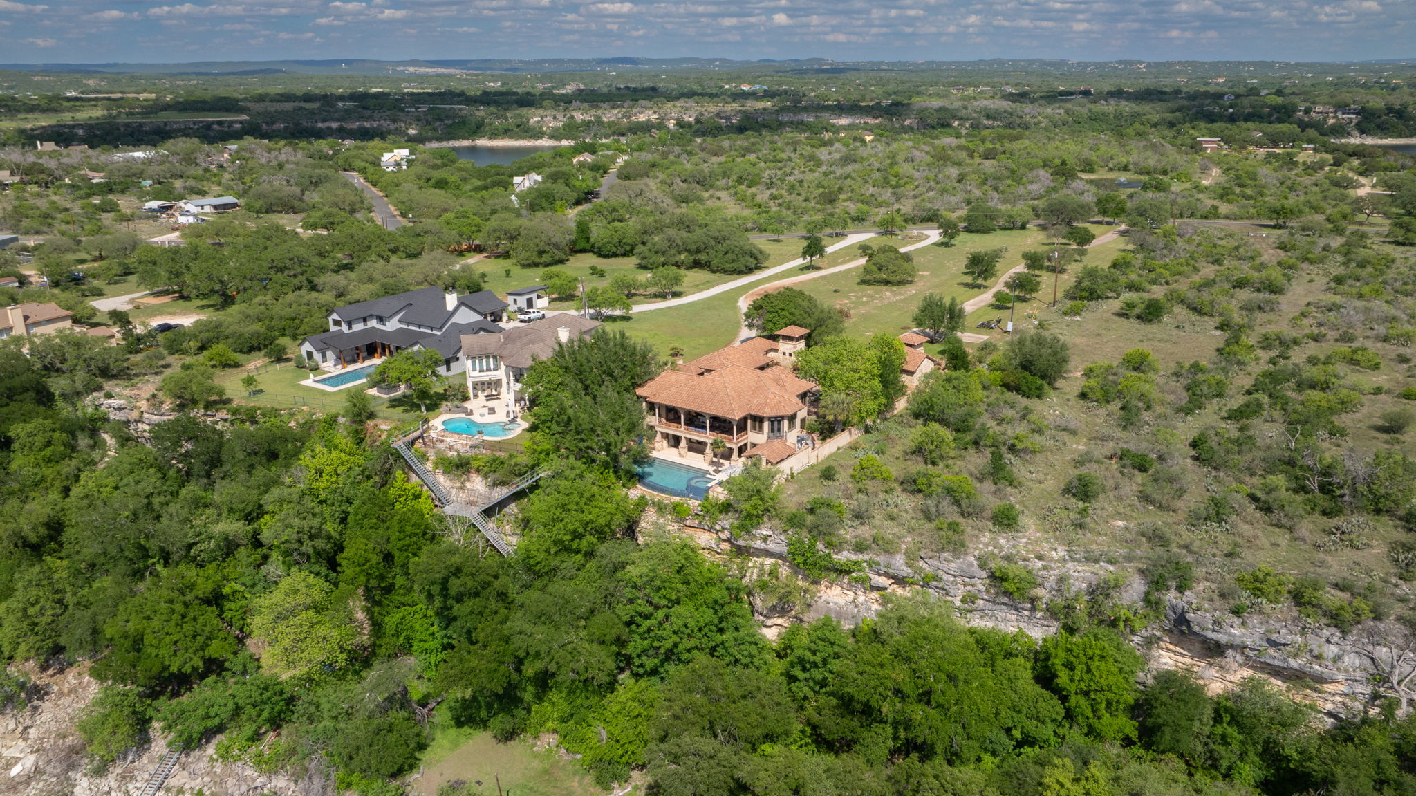 The property features a red tile roof and an outdoor pool.